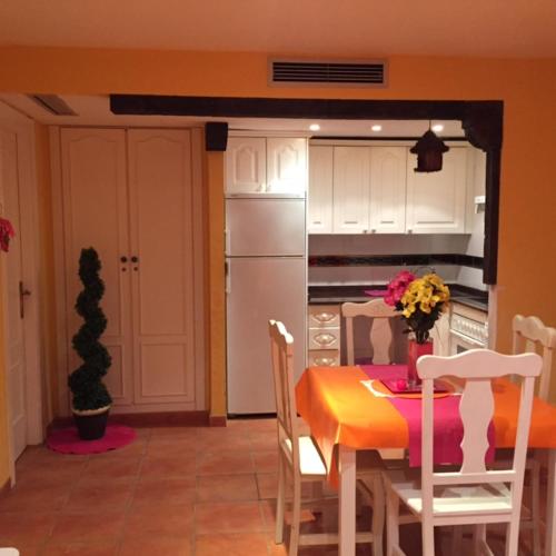a kitchen with a table and chairs and a refrigerator at Apartment Martinez Casablanca in Alcossebre