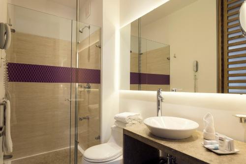 e bagno con servizi igienici, lavandino e doccia. di Mercure Bogota BH Retiro a Bogotá