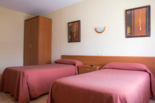 Postel nebo postele na pokoji v ubytování Hostal Restaurante María Victoria