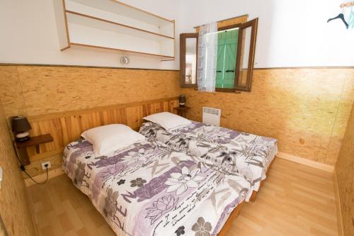 a bedroom with a bed and a window at Sarl Aurore-Vacances in Vico