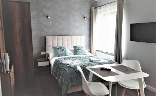 Postel nebo postele na pokoji v ubytování Vigan Apartamenty