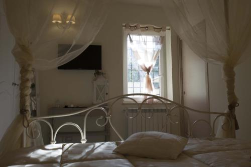a bed in a bedroom with a window at La Dolce Casetta in Grottaferrata