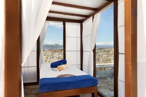 a room with a window with a bed and a view at Wyndham Loutraki Poseidon Resort in Loutraki