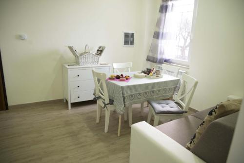 a dining room with a table and chairs and a dresser at La Dolce Casetta in Grottaferrata