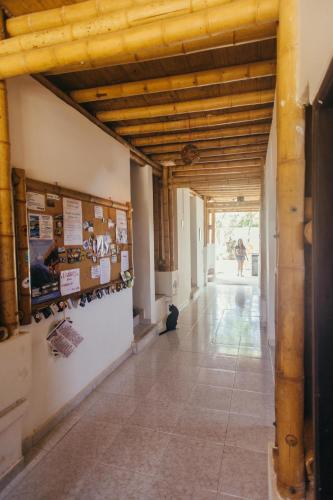 a hallway in a building with wooden ceilings at La Tortuga Hostel in Taganga