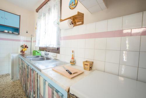 a kitchen with a sink and a counter top at Country House in Pastida