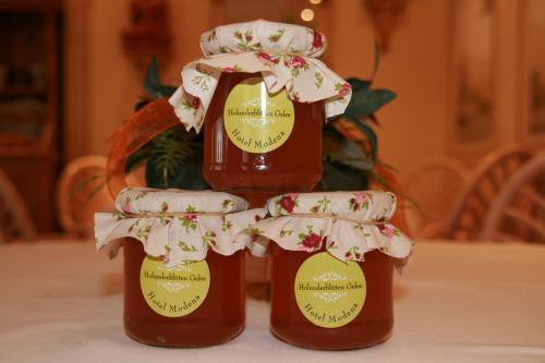 two bottles of honey sitting on a table at Hotel Modena in Bad Steben
