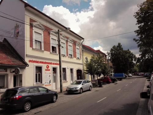 two cars parked on the side of a street at DownTown DeLuxe Apartment in Eger