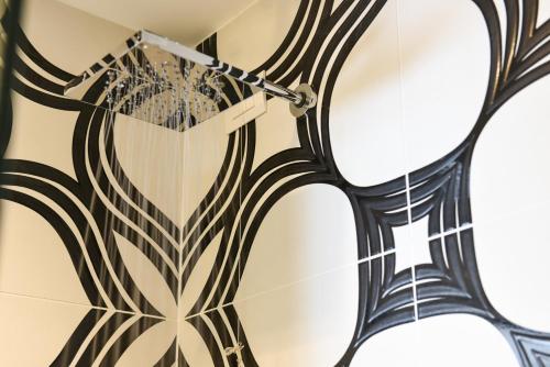 a mirror hanging on a wall with a design on it at On The Rock in Arco