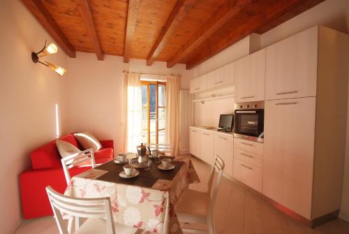 a living room with a table and a red couch at Villaggio delle Alpi in Pré-Saint-Didier