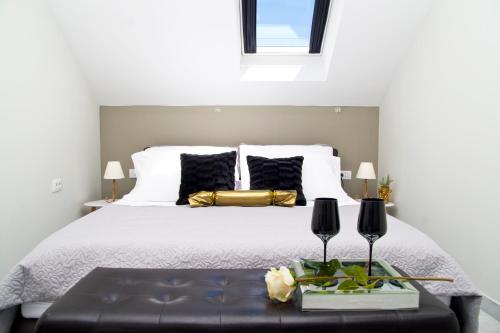 a bedroom with a white bed with black pillows at Split Center in Split