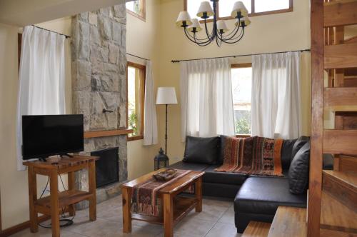 a living room with a couch and a fireplace at Rayen Mapu in San Carlos de Bariloche