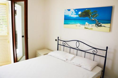 מיטה או מיטות בחדר ב-Giardino sul mare