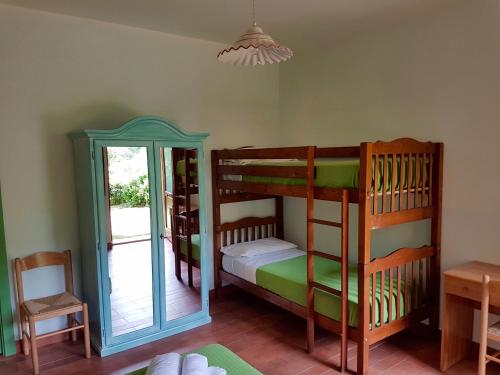 a bedroom with two bunk beds and a table at La Baita di Pilato in Montemonaco