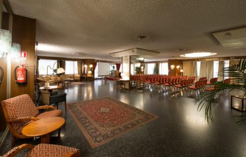 a large room with chairs and tables and a rug at Hotel Royal Palace in Messina
