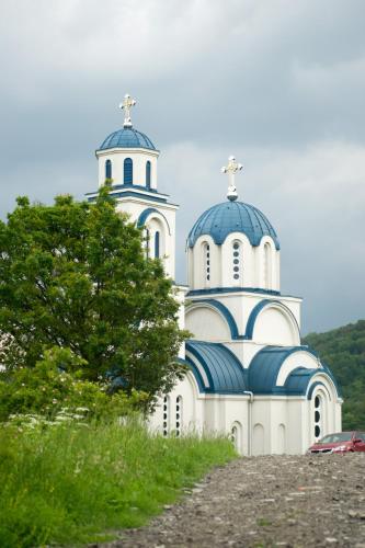 a white and blue church with two domes at Apartmani Mali Raj Rudnik in Rudnik Kačerski