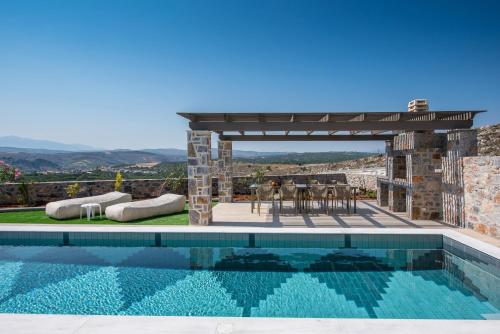 a pool with a gazebo and a table and chairs at Gregory Luxury Villa by Cretevasion in Anópolis