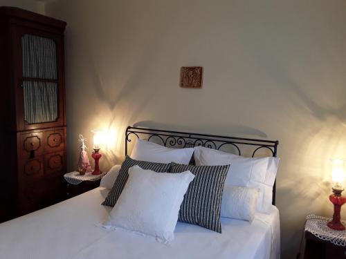 a bedroom with a bed with white sheets and pillows at Casa Castedo do Douro in Castedo