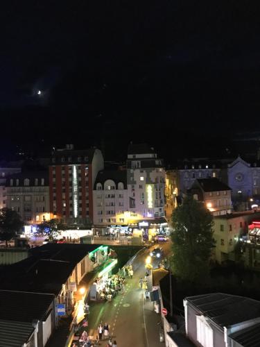 a view of a city at night with lights at Appart'hôtel Saint Jean in Lourdes