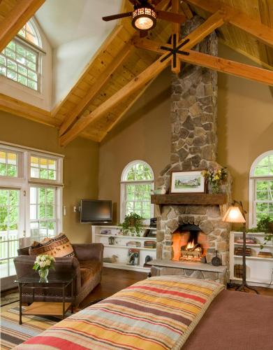 a living room with a stone fireplace and a couch at Sugar Hill Inn in Sugar Hill