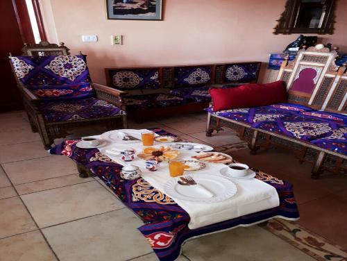 a living room with a table with food on it at Osiris Hotel Cairo in Cairo