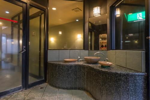 a bathroom with two sinks on a counter at Awara Grand Hotel in Awara
