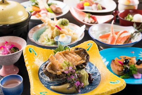 a table topped with plates of food on a table at Awara Grand Hotel in Awara