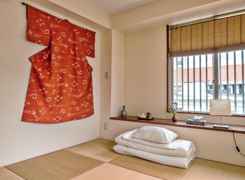 a bedroom with a white bed and a window at La Passione Boutique B&B in Naha