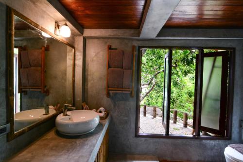 a bathroom with a sink and a large window at Sai Daeng Resort in Koh Tao