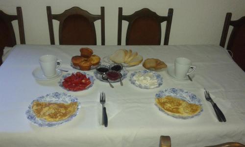 a table with plates of breakfast food on it at Rooms Lida & Friendly home in Plav