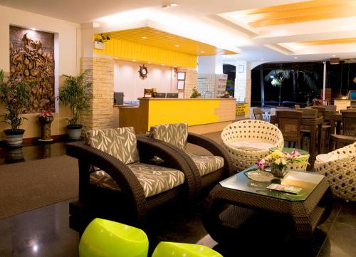 a lobby with couches and chairs and a table at Baan Boa Resort in Patong Beach