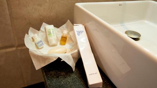 a box of toiletries sitting next to a sink at Hotel Golden View in Shirdi