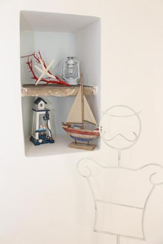 a shelf with a toy sailboat on it at Casetta Azzurra in Monopoli