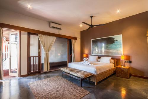 a bedroom with a bed and a large window at Villa Martine - Fantastic 5BR Villa - Perfect Location in Seminyak in Seminyak