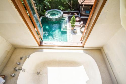 an overhead view of a bath tub with a pool at Villa Martine - Fantastic 5BR Villa - Perfect Location in Seminyak in Seminyak