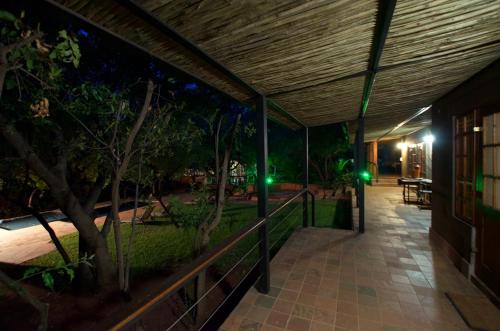 an outdoor walkway at night with green lights at Tuskers Bush Lodge B&B in Hartbeespoort