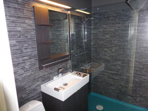 a bathroom with a sink and a shower and a toilet at Holiday Home Byvägen 38 in Nattavaara