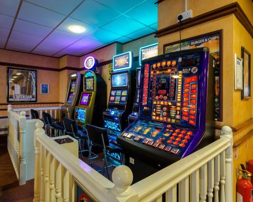 a lobby with several slot machines in a room at The Grand Burstin Hotel in Folkestone