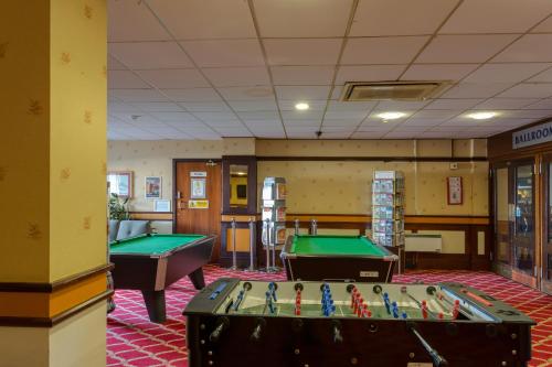 a billiard room with two pool tables in it at The Grand Burstin Hotel in Folkestone