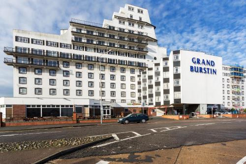 a car parked in front of a large building at The Grand Burstin Hotel in Folkestone