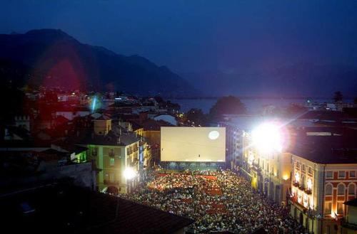 a crowd of people in a city at night at Cà di Noni in Gordevio