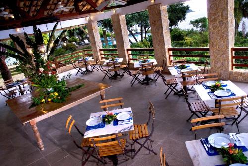 an outdoor dining area with tables and chairs at Santa Clara Hotel in Paraty