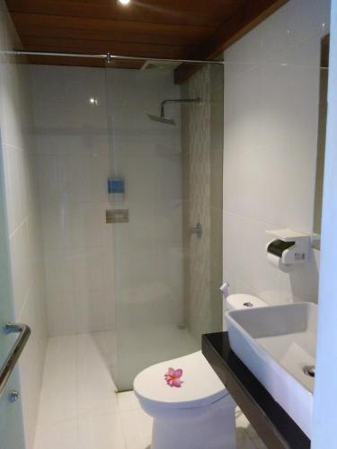 a bathroom with a shower and a toilet and a sink at Naturela in Uluwatu