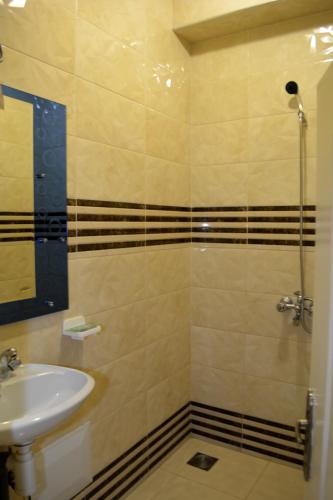 a bathroom with a sink and a shower at Dar Yasser in Marrakech