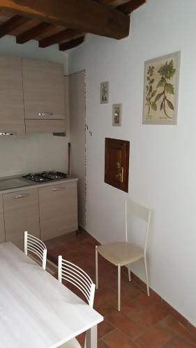 a kitchen with a table and chairs in a room at Casa dei Borghi in Murlo