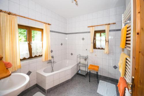 a white bathroom with a tub and a sink at Oberbach in Strohmarkt