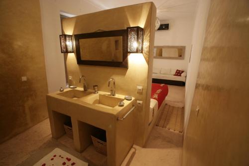 a bathroom with a sink and a mirror at Riad De Vinci & SPA in Marrakech