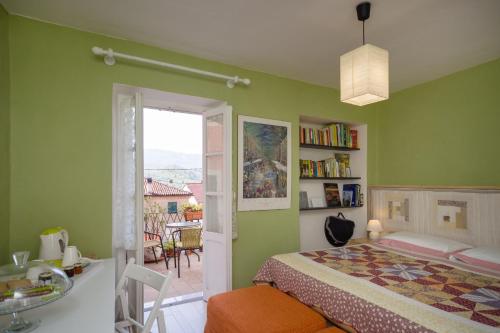 um quarto com paredes verdes, uma cama e uma janela em Casa Bosio em Bosio