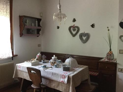 a dining room with a table with hearts on the wall at BnB Trento in Trento