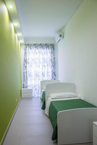 Postel nebo postele na pokoji v ubytování Residence Palazzo dei Delfini by RECEPTIO